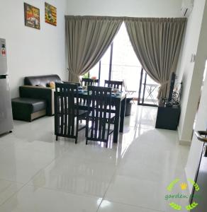 a living room with a table and chairs and a couch at °Garden Bay°country garden danga bay JOHOR in Johor Bahru