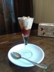 a drink on a plate with a spoon on a table at Villa Floren Castro Urdiales in Castro-Urdiales