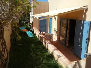a small yard with a patio and an awning at Manta Rota Beach, apartment in a villa, terrace,garden in Manta Rota