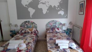 Postel nebo postele na pokoji v ubytování B&B Il MappaMondo