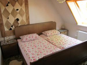a bedroom with a bed with pink sheets and a window at Haus Annegret in Wietzendorf