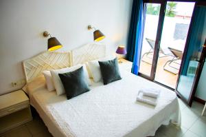 een slaapkamer met een bed met 2 lampen en een balkon bij Villa La Concha in Playa Honda