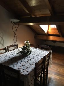 a dining room table with a flower arrangement on it at Antico Borgo dell'Anconella - grande appartamento rustico in Anconella