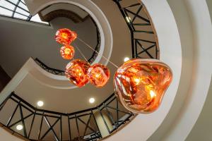 three glass hearts hanging from a spiral staircase at Hotel Boutique Calas de Alicante in Alicante