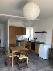a kitchen with a wooden table and chairs and a light fixture at Muralto-Locarno: Miramonti Apt. 8 in Muralto