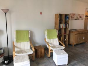 a room with two chairs and a book shelf at Muralto-Locarno: Miramonti Apt. 8 in Muralto