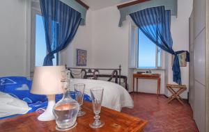 a bedroom with a bed and a table with glasses on it at Villa Eugenia in Livorno
