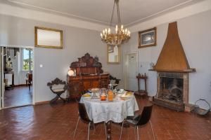 a dining room with a table and a fireplace at Villa Eugenia in Livorno