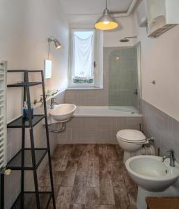 a bathroom with two sinks and a tub and a toilet at Villa Eugenia in Livorno +37 photos