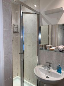 y baño con ducha, lavamanos y ducha. en Rivendell Guest House en Southampton