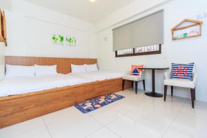 Postel nebo postele na pokoji v ubytování Yilan Dongshan Cypress B&B