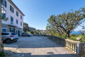 a parking lot with two cars parked next to a building at Villa Eugenia in Livorno
