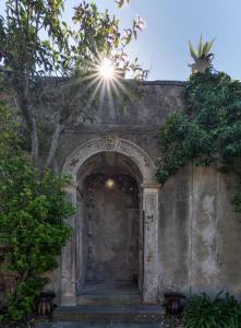 an entrance to a building with the sun shining over it at Villa Eugenia in Livorno