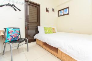 Postel nebo postele na pokoji v ubytování Yilan Dongshan Cypress B&B