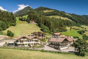 an aerial view of a mansion in the mountains at XL Appartements Steinhaus in Cadipietra