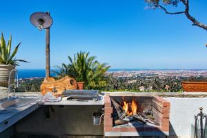 a kitchen with a fire pit and a view of the city at Villa Eugenia in Livorno