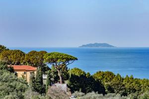a house on a hill next to the ocean at Villa Eugenia in Livorno