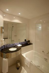 a bathroom with a tub and a sink and a shower at Holiday Inn Express Málaga Airport, an IHG Hotel in Málaga