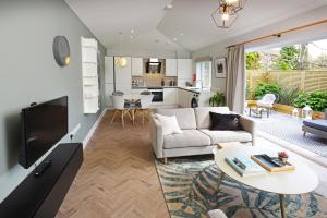 a living room with a couch and a table at West House, 36A Whitstable Road in Canterbury
