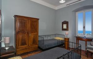 a bedroom with a bed and a wooden cabinet at Villa Eugenia in Livorno