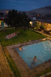 
A view of the pool at The Upcycled Hostel Huacachina or nearby
