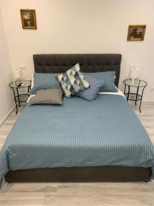 a bed with blue sheets and pillows in a bedroom at Di Palma Suite Museum in Naples