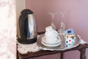 a coffee maker sitting on a table with a cup of coffee at Hotel Florence in Manerba del Garda