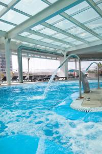 a swimming pool with a water fountain at Antay Hotel & Spa in Arica