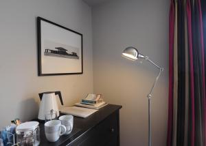 a desk with a lamp on top of a dresser at Crown and Castle in Orford