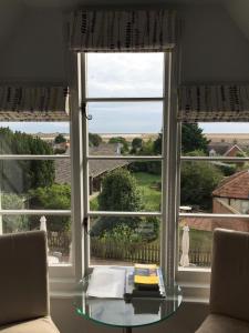 a table in front of a window with a view at Crown and Castle in Orford