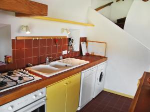 a kitchen with a sink and a stove at Holiday Home Les Geais-1 by Interhome in Saint-Saturnin-lès-Apt