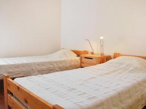 a bedroom with two beds and a night stand with a lamp at Holiday Home Les Geais by Interhome in Saint-Saturnin-les-Apt +11 photos
