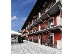 a building with red walls and balconies on a street at Stella Alpina Hotel e Ristorante in Druogno