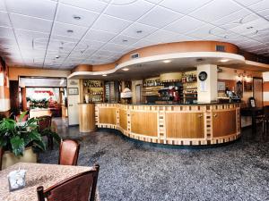 a lobby of a restaurant with a bar at Stella Alpina Hotel e Ristorante in Druogno