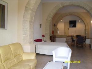 a bedroom with a bed and a living room at LA CHAPELLE DU PRIEURE in Alignan-du-Vent +9 photos