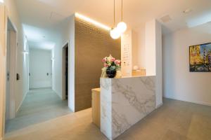a lobby with a marble counter with flowers on it at Garda Room in Peschiera del Garda