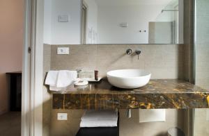 a bathroom with a sink on a marble counter at Garda Room in Peschiera del Garda +20 photos