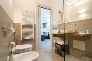 a bathroom with a sink and a toilet and a mirror at Garda Room in Peschiera del Garda
