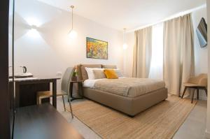 a bedroom with a bed and a table and a desk at Garda Room in Peschiera del Garda