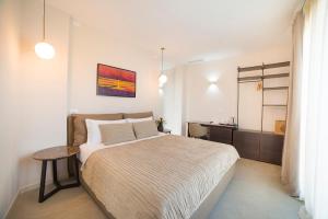 a bedroom with a bed and a table in it at Garda Room in Peschiera del Garda