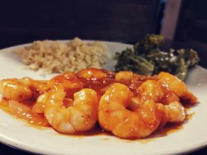 a plate of food with shrimp and rice and broccoli at La Familia in San Blas