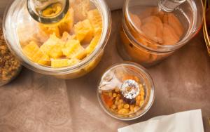 three jars of food sitting on a table at Garda Room in Peschiera del Garda