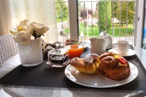 a table with a plate of pastries on it at Garda Room in Peschiera del Garda