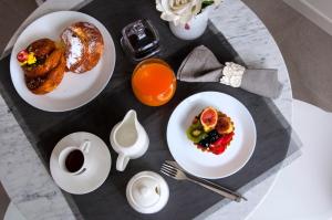 a table with plates of breakfast foods on it at Garda Room in Peschiera del Garda
