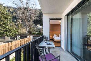 a balcony of a house with a table and chairs at Apartment 39012 in Merano