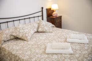 a bedroom with a bed with two pillows on it at Casa Camelia in Noto