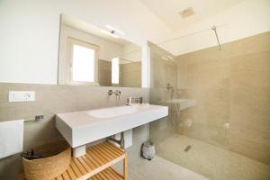 a bathroom with a white sink and a shower at Garda Room in Peschiera del Garda