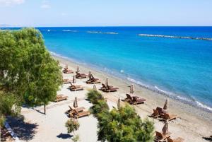 an overhead view of a beach with chairs and the ocean at Villa Charoula Tessera in Polis Chrysochous
