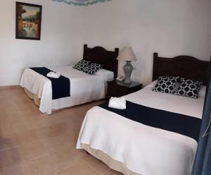 Postel nebo postele na pokoji v ubytování Hotel Zaci