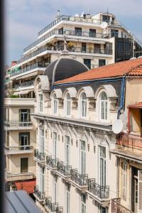 a tall white building with a domed roof at Evapollo in Thessaloniki